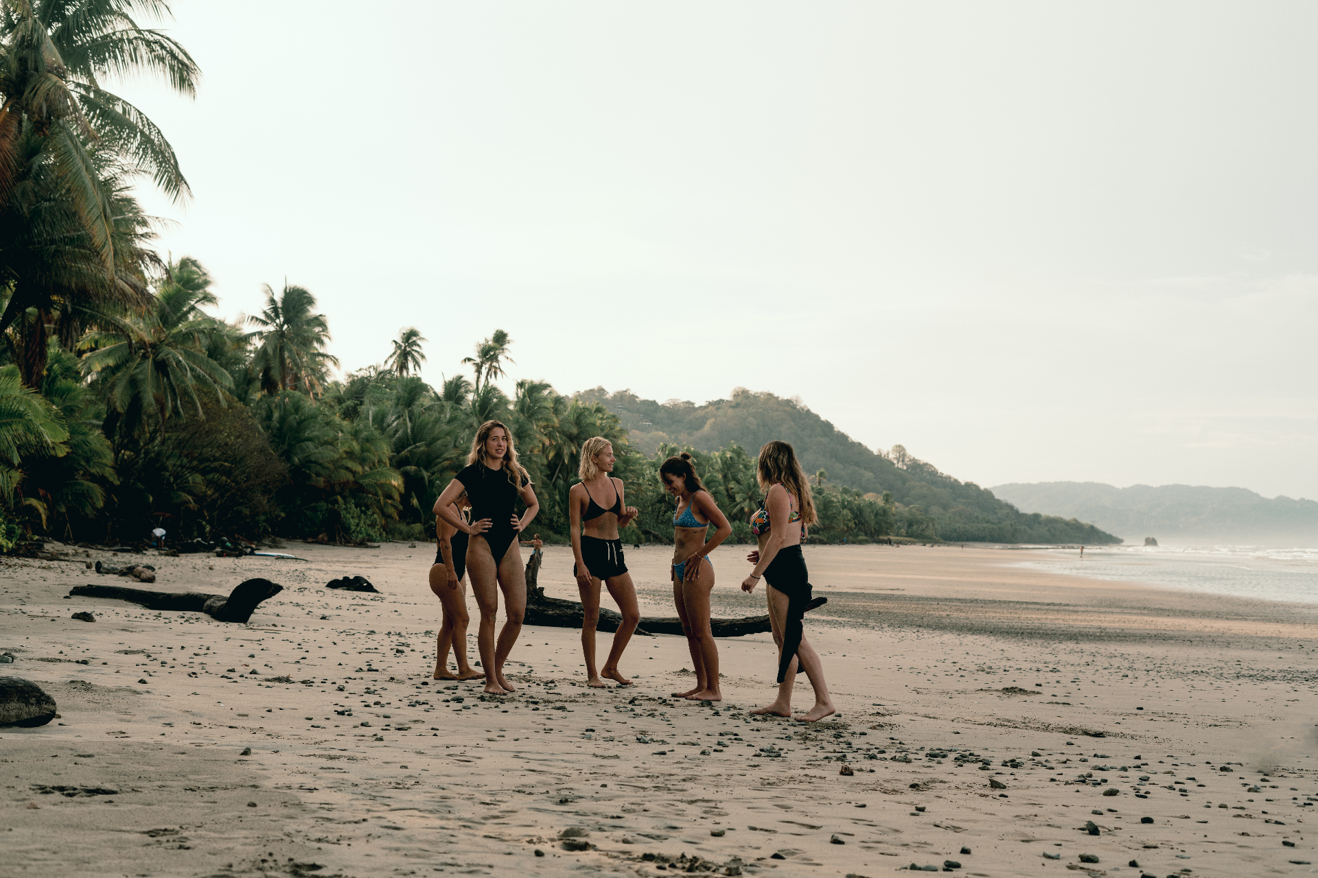 Women's retreat group hanging out together on the beach at Santa Teresa